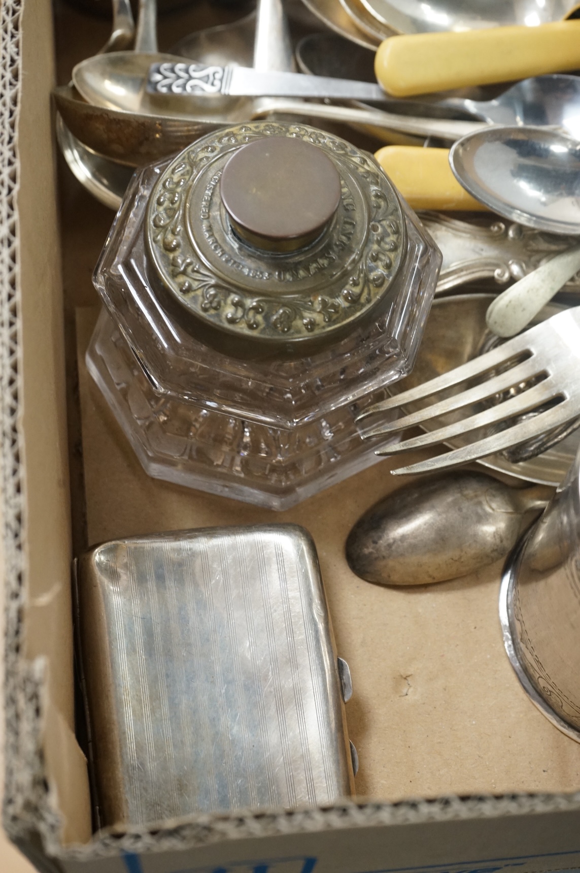 A pair of Victorian silver King's pattern table spoons by George Adams, London, 1858, a silver teaspoon, a mounted glass scent bottle, a silver cigarette case, a continental canister with inset coin lid, and assorted pla